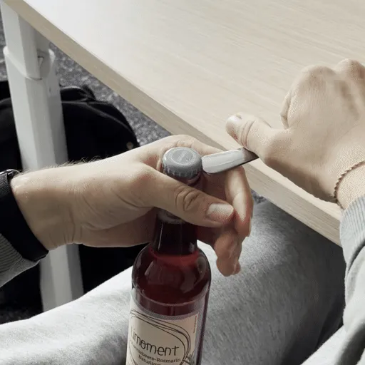 Eine Flasche wird mit einer Gabel geöffnet
