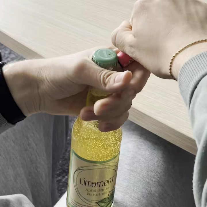 Eine Flasche wird mit einem Feuerzeug geöffnet